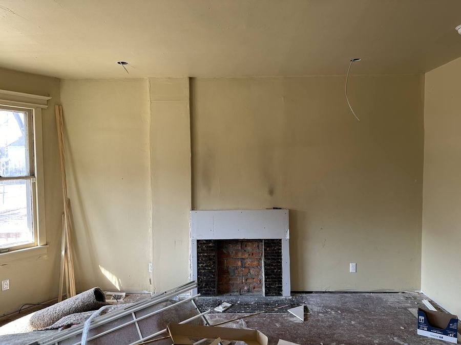 Living room with fireplace before rehab, Detroit